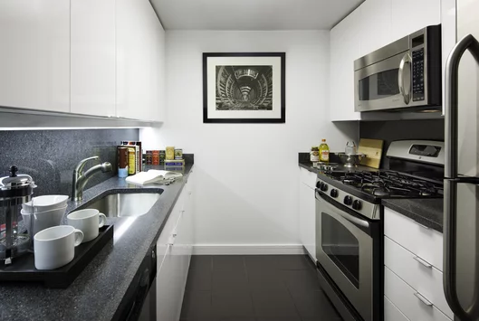 Gourmet kitchen featuring charcoal stone counters