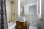 Bathrooms feature golden sandstone tile with arctic white corian vessel sinks.