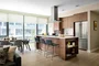 Custom walnut kitchen cabinetry, polished quartz countertops and Calacatta marble backsplash.