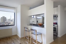 The gourmet kitchen at One Union Square South features Euro-style cabinetry and granite countertops.