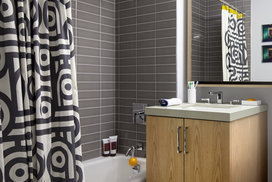 Luxurious tiled baths feature custom wood cabinetry and oversized custom-designed medicine cabinets.