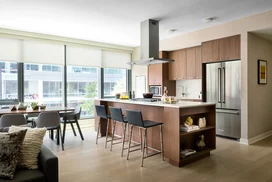 Custom walnut kitchen cabinetry, polished quartz countertops and Calacatta marble backsplash.