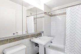 Classic marble bathrooms include charming pedestal sinks. 