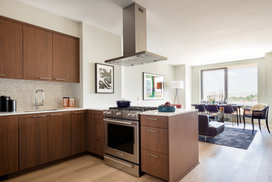 Custom walnut kitchen cabinetry, polished quartz countertops and Calacatta marble backsplash.