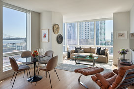 Floor-to-ceiling windows provide maximum natural light and showcase sweeping water and city views