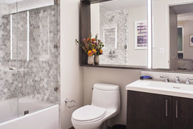 Inspired baths include a marble tub surround and glass enclosed shower, custom vanity and medicine cabinet.