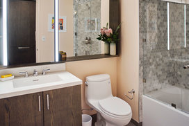 Inspired baths include a marble tub surround and glass enclosed shower, custom vanity and medicine cabinet.