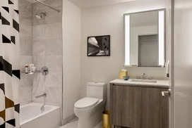 Well-appointed master bathrooms feature vanities with Italian white marble, grey marble walls, and medicine cabinets with integrated lighting and pulls.