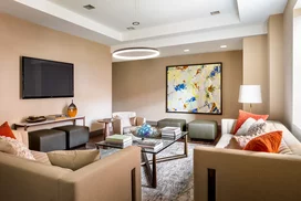 Relax and socialize with friends in an intimate club setting with a large screen TV, open kitchen and lots of comfy chairs.