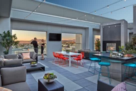 Rooftop terrace with dining tables and BBQ grills.