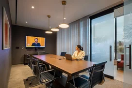 The resident-only co-working lounge includes individual workstations, private offices, and conferencing spaces.