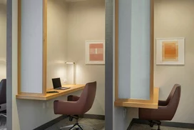 The resident-only co-working lounge includes individual workstations, private offices, and conferencing spaces.