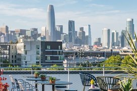 Rooftop Terrace with barbecue grills, fire pits and outdoor TVs set against views of the city skyline