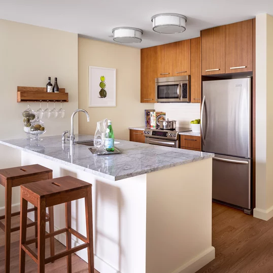 Walnut cabinetry, Italian marble countertops, and stainless steel appliances are just a few of the many ingredients that make these kitchens any chef's dream-come-true.